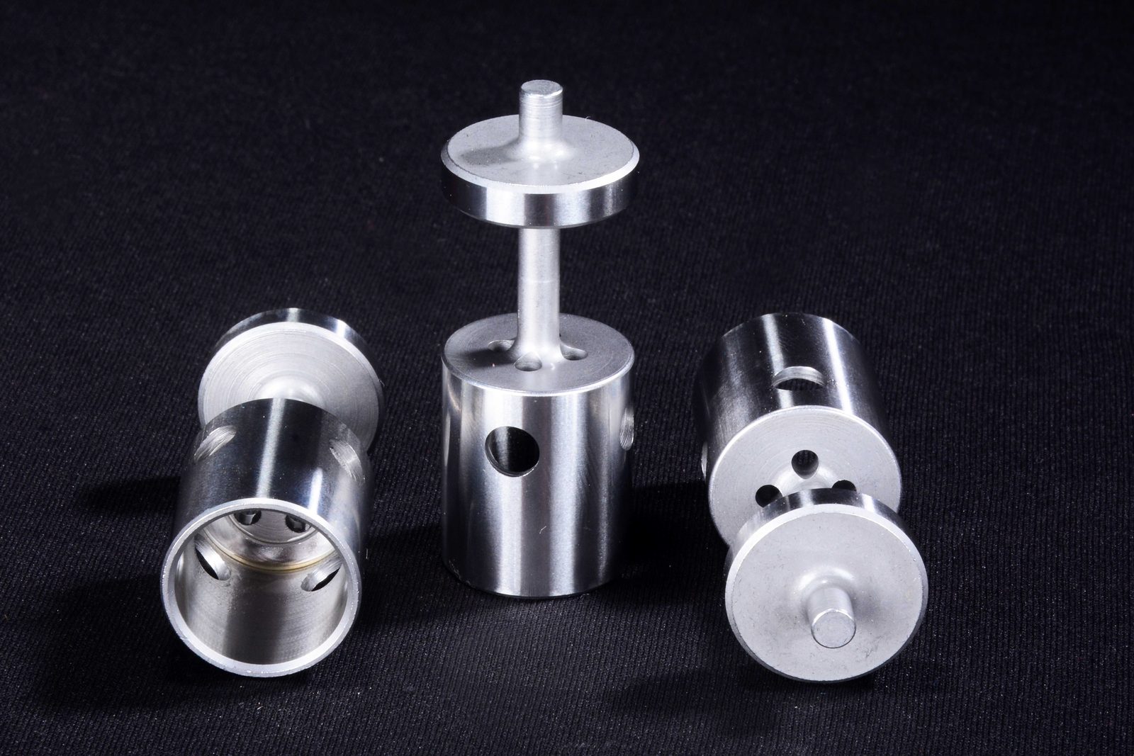 Machined aluminium fuel system components - a poppet valve with a slender stem and two cross-drilled cylindrical bodies