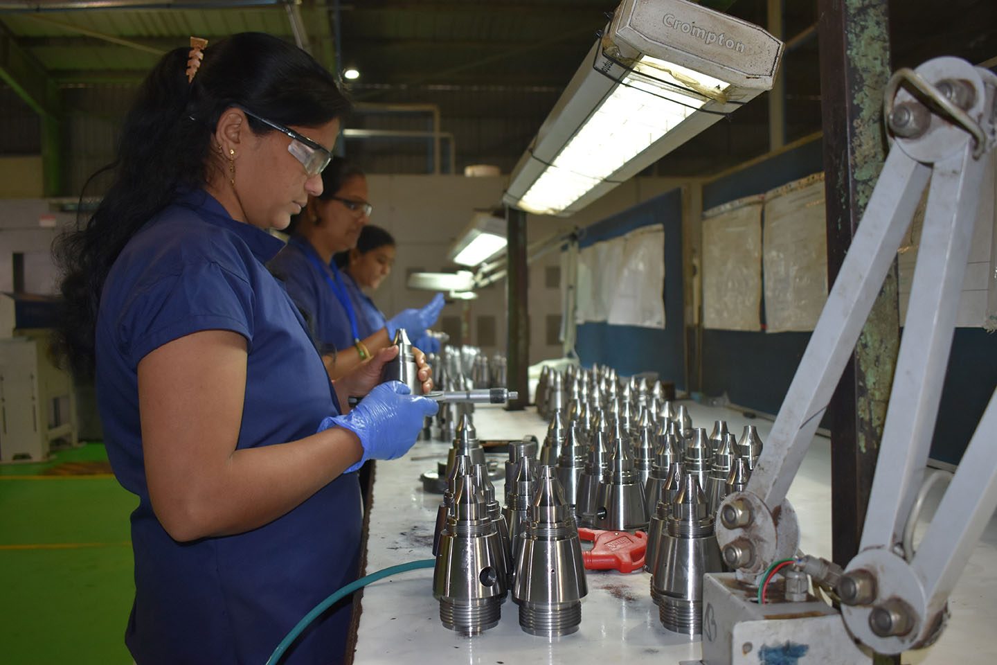 PSCPL inspectors gauging rows of machined fuse bodies on the inspection line